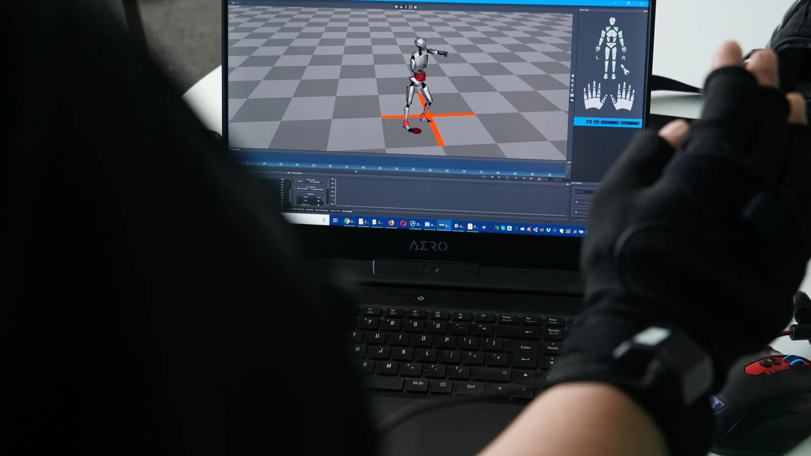 Tracked glove controlling a digital character on a laptop during motion capture development.