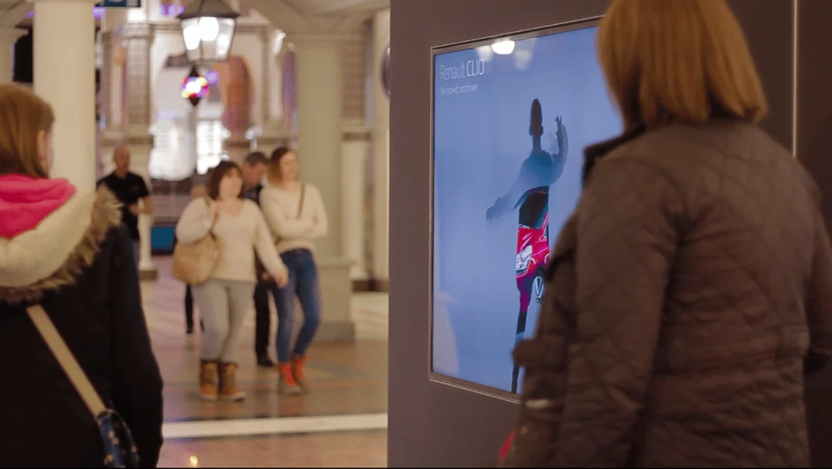 Visitor using a Renault interactive display with a personalised avatar in a shopping centre.