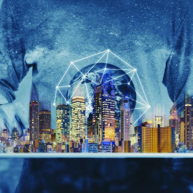 Network globe and miniature illuminated city above a tablet in the unReal City artwork.
